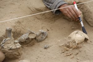 A man works on the remains of a child at the Bosque de Pomac archaeological complex in Lambayeque, Peru, Monday, July 19, 2010. According to archaeologist Carlos Elera, four 1,200-year old tombs, belonging to the Sican culture, where found during excavation works. (AP Photo/Karel Navarro)