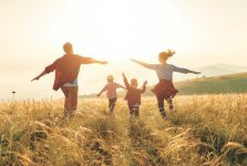 Happy family: mother, father, children son and daughter on sunset